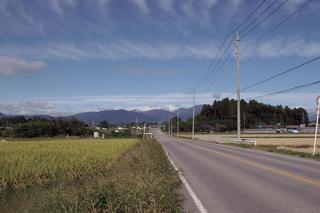 左側は畑で右側には道路がある槻沢遺跡の写真